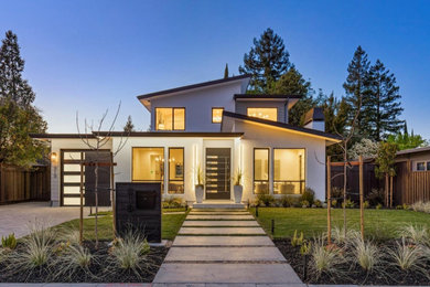 Example of a minimalist two-story stucco house exterior design in San Francisco with a shed roof