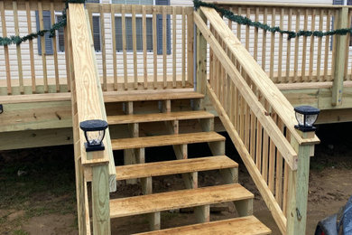 Deck - mid-sized rustic backyard ground level wood railing deck idea in Other with no cover