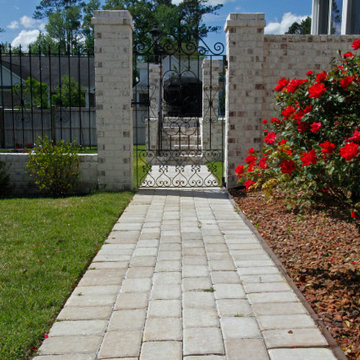 Paver Path with Intricate Wrought Iron Gate