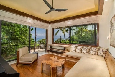 Design ideas for a mid-sized tropical enclosed living room in Hawaii with beige walls and light hardwood floors.