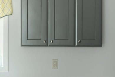 Eat-in kitchen - mid-sized transitional u-shaped brown floor eat-in kitchen idea in Other with an undermount sink, recessed-panel cabinets, gray cabinets, quartz countertops, stainless steel appliances, no island and gray countertops