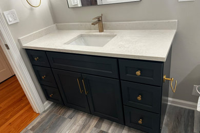 Bathroom - mid-sized modern 3/4 black and white tile and porcelain tile porcelain tile and single-sink bathroom idea in Chicago with shaker cabinets, dark wood cabinets, a one-piece toilet, beige walls, an undermount sink, quartz countertops, a hinged shower door, beige countertops and a built-in vanity