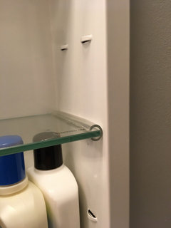 Medicine cabinet shelf supports