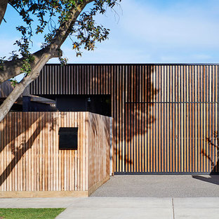 Inspiration for a beach style one-storey brown house exterior in Geelong with wood siding and a flat roof.