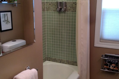 Bathroom - mid-sized traditional 3/4 green tile and glass tile brown floor bathroom idea in Columbus with dark wood cabinets, green walls, an integrated sink and glass countertops