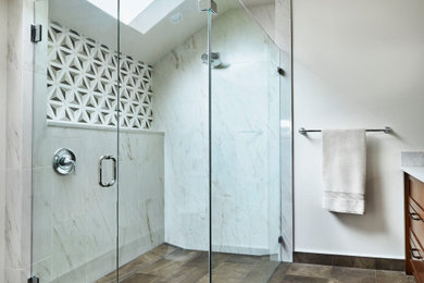 This is an example of a mid-sized master bathroom in Portland with shaker cabinets, medium wood cabinets, a curbless shower, gray tile, porcelain tile, white walls, porcelain floors, an undermount sink, engineered quartz benchtops, brown floor, a hinged shower door, grey benchtops, a double vanity, a built-in vanity and vaulted.