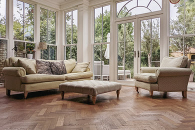 This is an example of a medium sized contemporary living room in London with medium hardwood flooring and brown floors.