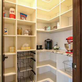 Craftsman kitchen pantry inspiration - Example of an arts and crafts l-shaped light wood floor kitchen pantry design in Milwaukee with an undermount sink, shaker cabinets, white cabinets, granite countertops, white backsplash, subway tile backsplash, stainless steel appliances and an island