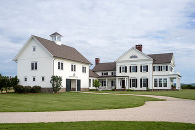 Large cottage white two-story wood exterior home photo in Bridgeport with a shingle roof