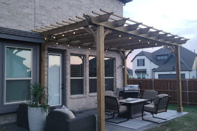 Patio - mid-sized modern backyard patio idea in Dallas with a pergola