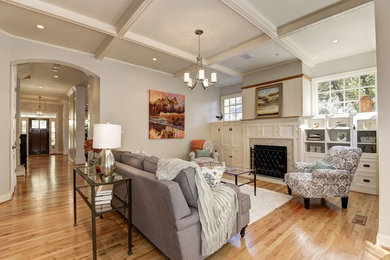 Large arts and crafts open concept light wood floor and brown floor family room photo in DC Metro with beige walls, a standard fireplace, a stone fireplace and a concealed tv