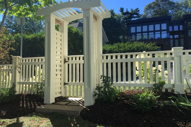 Design ideas for a mid-sized traditional partial sun backyard stone retaining wall landscape in Other for summer.