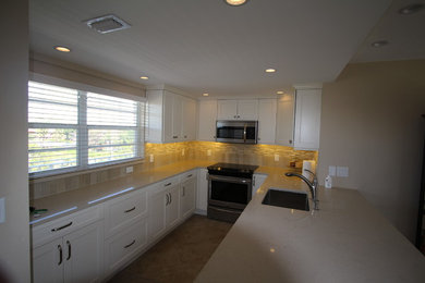 Large trendy u-shaped medium tone wood floor eat-in kitchen photo in Miami with an undermount sink, shaker cabinets, white cabinets, quartz countertops, beige backsplash, stone tile backsplash, stainless steel appliances and a peninsula
