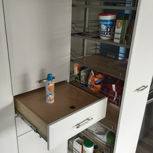 Mid-sized traditional kitchen pantry designs - Example of a mid-sized classic single-wall kitchen pantry design in Manchester with flat-panel cabinets and white cabinets