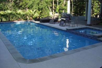 Hot tub - large modern backyard custom-shaped natural hot tub idea in Dallas