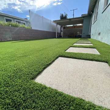 Pet-Friendly Side Yard with Artificial Turf and Concrete Stepping Stones In Lomi