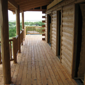 Half log siding, cedar porch and cedar deck railing