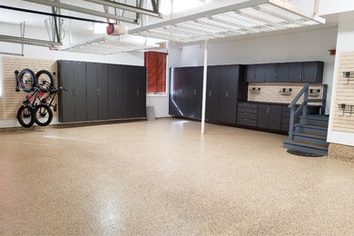 Garage workshop - large modern attached three-car garage workshop idea in Chicago