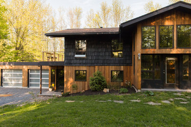 Photo of a contemporary exterior in Burlington with wood siding.