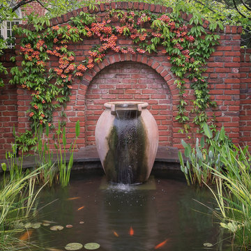 Koi pond with Lunaform urn with cross vine blooming