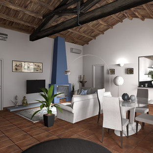 Foto de salón abierto, mediterráneo, extra grande, con paredes blancas, suelo de baldosas de terracota, chimenea tradicional, marco de chimenea de yeso, televisor colgado en la pared y suelo naranja