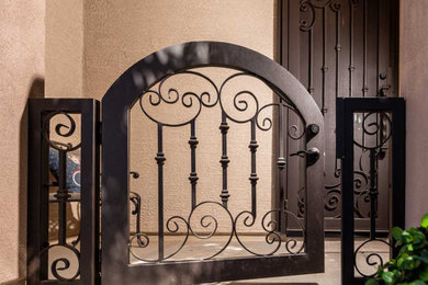 This is an example of a small french country front porch design in Phoenix.