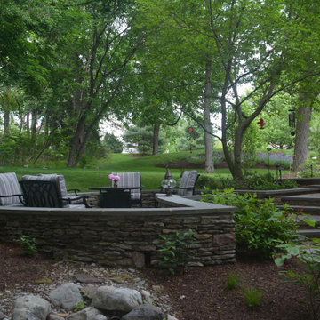 Patio above and at grade with drainage run.