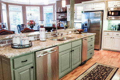 This is an example of a mid-sized traditional eat-in kitchen in Atlanta with a double-bowl sink, raised-panel cabinets, white cabinets, granite benchtops, brown splashback, subway tile splashback, stainless steel appliances, medium hardwood floors, with island and brown floor.