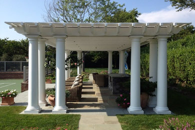 Design ideas for a mid-sized traditional backyard patio in New York with a pergola.