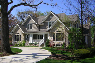 Inspiration for a large transitional gray two-story mixed siding exterior home remodel in Chicago with a hip roof
