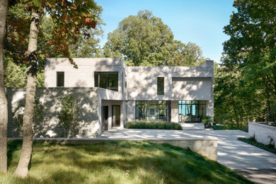 Inspiration for a large contemporary beige two-story brick exterior home remodel in Chicago