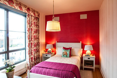 This is an example of a small contemporary guest bedroom in New York with red walls, medium hardwood floors, no fireplace and brown floor.