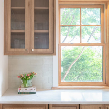 Warm Modern Kitchen Renovation with Natural Oak & Green Accents