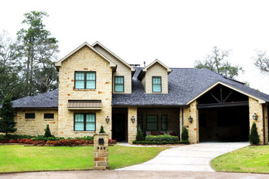 Example of a transitional beige two-story brick house exterior design in Houston