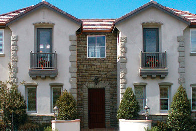 Large traditional two-storey exterior in Orange County with stone veneer.