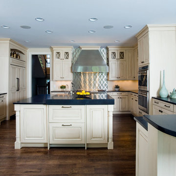 Quilted metal backsplash above range with multi-level center island