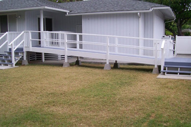 Example of a mid-sized island style blue one-story wood exterior home design in Other with a hip roof