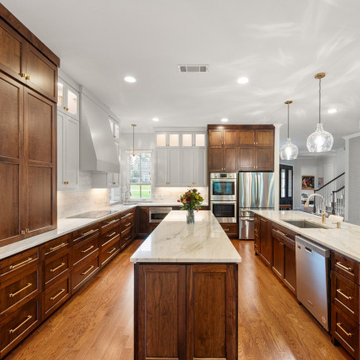 Wide wide-angle view of luxury kitchen featuring dual parallel islands