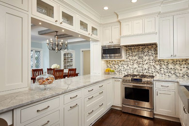 Transitional u-shaped medium tone wood floor eat-in kitchen photo in Chicago with a farmhouse sink, shaker cabinets, white cabinets, quartzite countertops, multicolored backsplash, stainless steel appliances and a peninsula