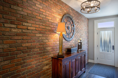 Hallway - mid-sized industrial dark wood floor hallway idea in Columbus with red walls
