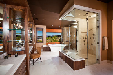 Large trendy master beige tile and stone tile marble floor bathroom photo in Las Vegas with an undermount sink, flat-panel cabinets, medium tone wood cabinets, brown walls and marble countertops