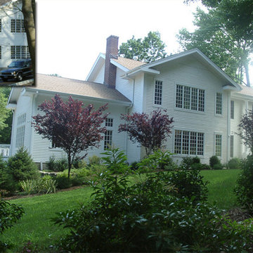 Purple plum trees anchor the house to site. Layers of plantings add depth to the