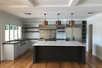 Design ideas for a large contemporary l-shaped open plan kitchen in Wollongong with a double-bowl sink, white cabinets, marble benchtops, multi-coloured splashback, stainless steel appliances, medium hardwood floors, with island and shaker cabinets.