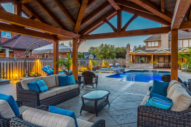 Mid-sized elegant backyard stamped concrete and rectangular hot tub photo in Toronto