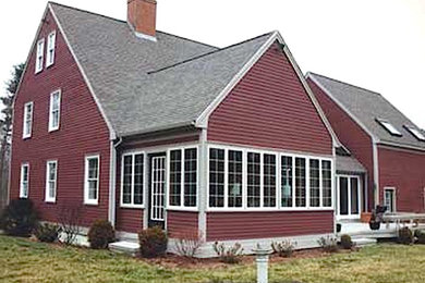 Design ideas for a large traditional two-storey red exterior in Boston with vinyl siding and a gable roof.