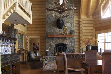 Inspiration for a mid-sized rustic formal and open concept dark wood floor and brown floor living room remodel in Burlington with beige walls, a standard fireplace, a stone fireplace and no tv