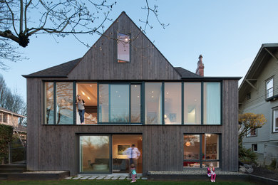 Trendy three-story wood exterior home photo in Seattle