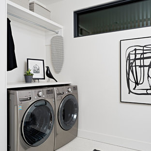 Medium sized modern galley utility room in Other with a submerged sink, flat-panel cabinets, engineered stone countertops, white walls, porcelain flooring, a side by side washer and dryer, white floors and white worktops.