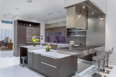 Mid-sized minimalist l-shaped ceramic tile, white floor and coffered ceiling kitchen photo in Toronto with an undermount sink, flat-panel cabinets, brown cabinets, brown backsplash, stainless steel appliances, an island and white countertops