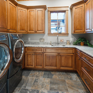 中サイズのラスティックスタイルのおしゃれな洗濯室 (アンダーカウンターシンク、シェーカースタイル扉のキャビネット、中間色木目調キャビネット、白い壁、左右配置の洗濯機・乾燥機、マルチカラーの床、グレーのキッチンカウンター) の写真